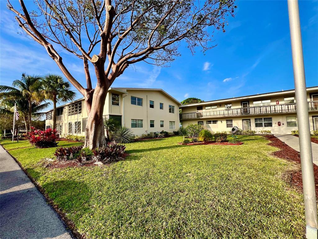 17 Markham A, Unit 17 Deerfield Beach, FL 33442 - Photo 26 of 50 a front view of a house with garden