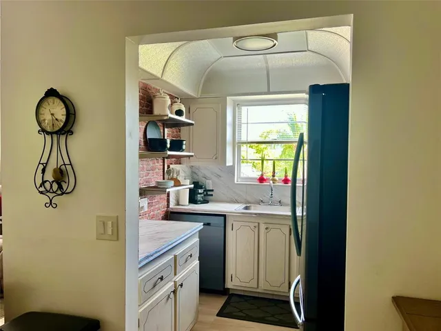 a kitchen with stainless steel appliances a stove a refrigerator and cabinets