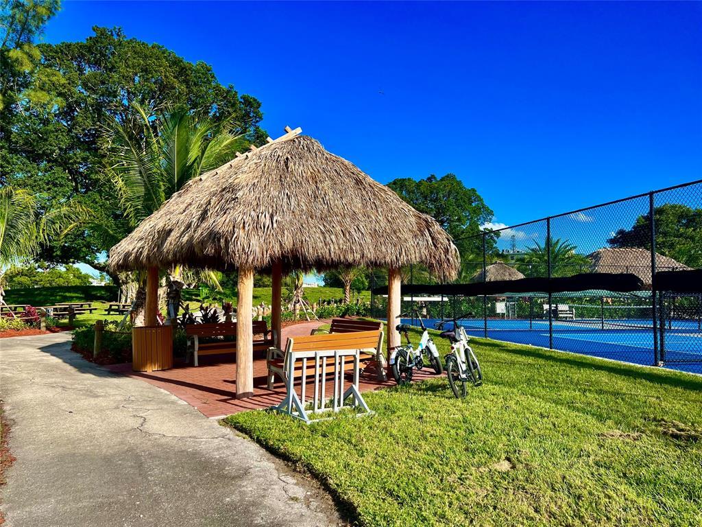 17 Markham A, Unit 17 Deerfield Beach, FL 33442 - Photo 38 of 50 a view of lawn chairs under an umbrella