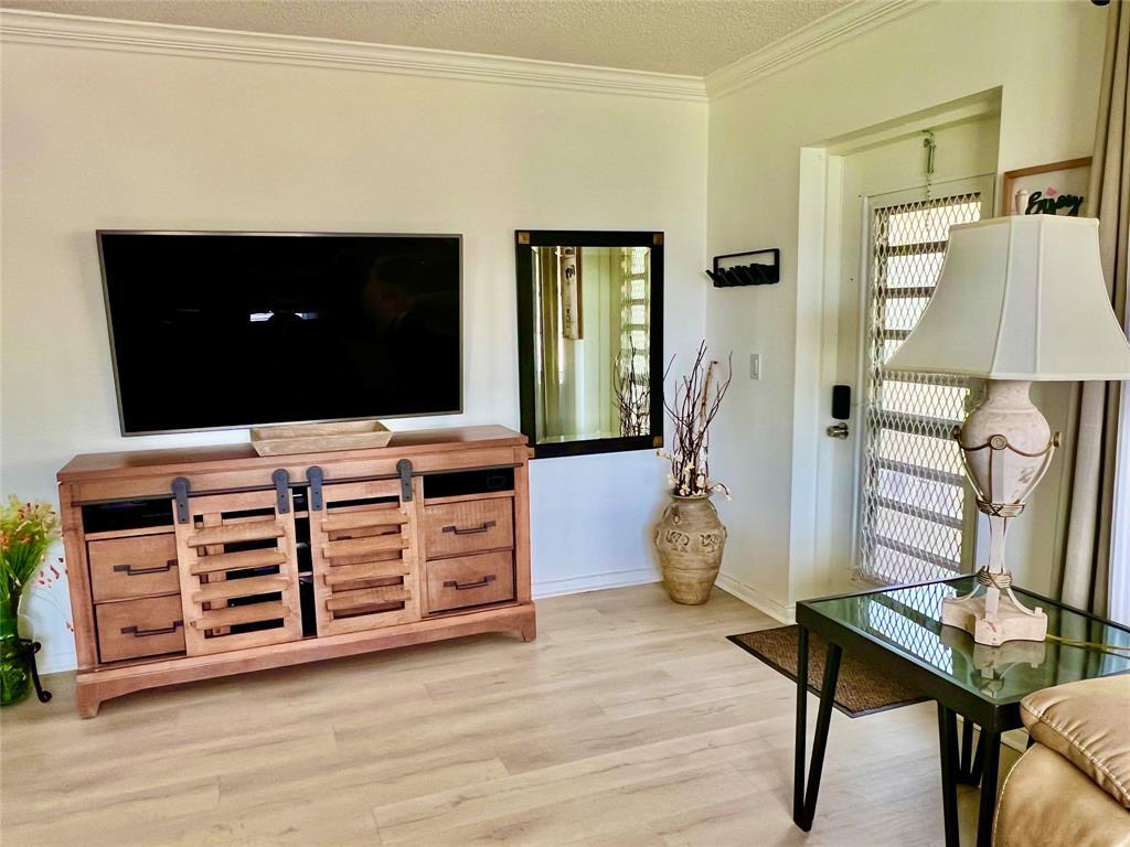 17 Markham A, Unit 17 Deerfield Beach, FL 33442 - Photo 7 of 50 a room with furniture and wooden floor