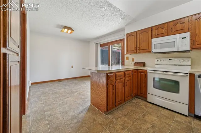 a kitchen with stainless steel appliances a stove and a refrigerator