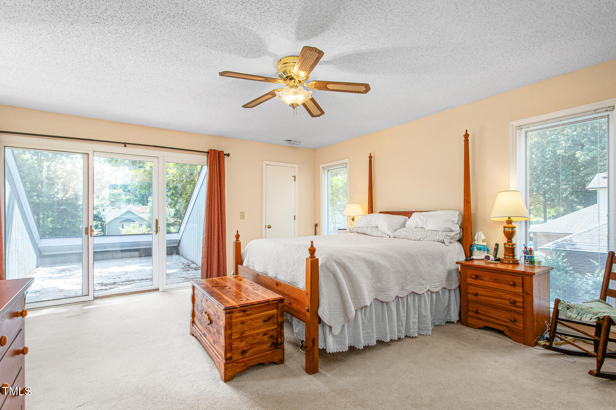 809 Brookview Drive Elon, NC 27244 - Photo 25 of 53 a bedroom with a bed and a chandelier