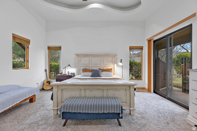98 Bridge Road Rockville, UT 84763 - Photo 16 of 75 Primary Suite – Pool Patio Access. Carpeted bedroom with access to exterior, ceiling fan, and a raised ceiling