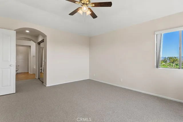 a view of a hallway with wooden floor and a living room