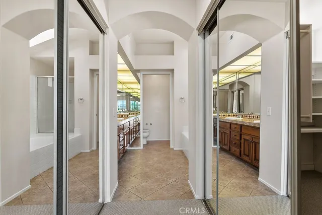 a bathroom with a tub sink shower and mirror