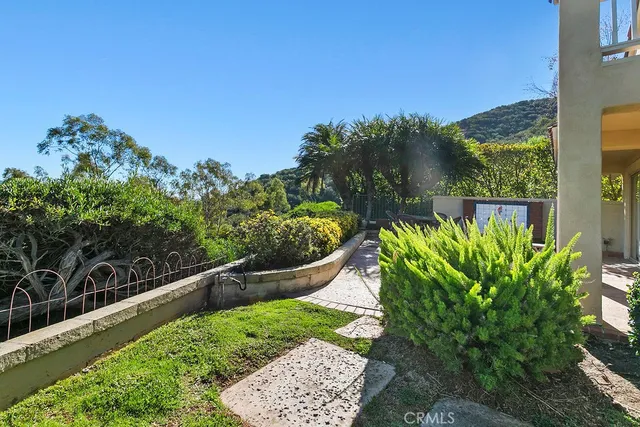 a view of a backyard with table and chairs under an umbrella