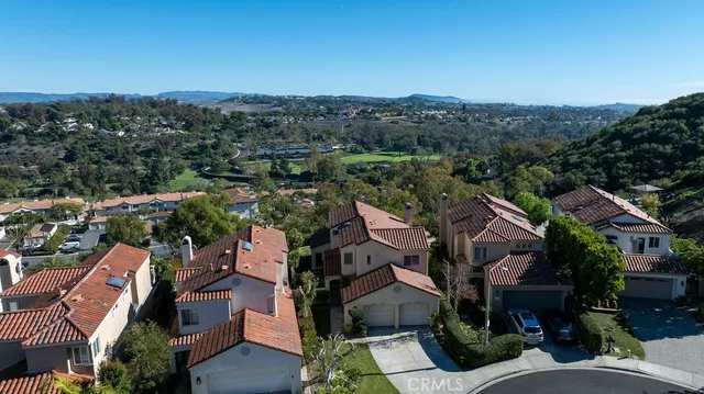 an aerial view of a house with a yard