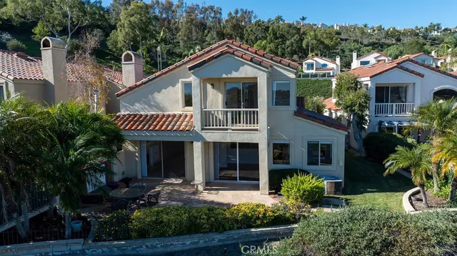 an aerial view of residential house with swimming pool and mountains