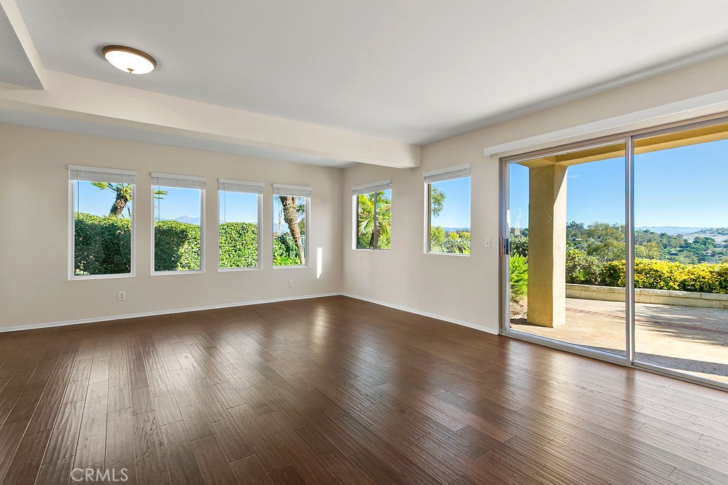 30942 Calle Moraga Laguna Niguel, CA 92677 - Photo 6 of 40 a view of an empty room with wooden floor and a window