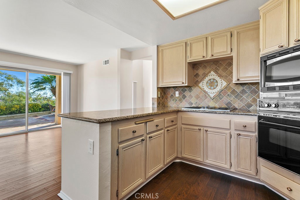 30942 Calle Moraga Laguna Niguel, CA 92677 - Photo 10 of 40 a kitchen with granite countertop white cabinets and white appliances
