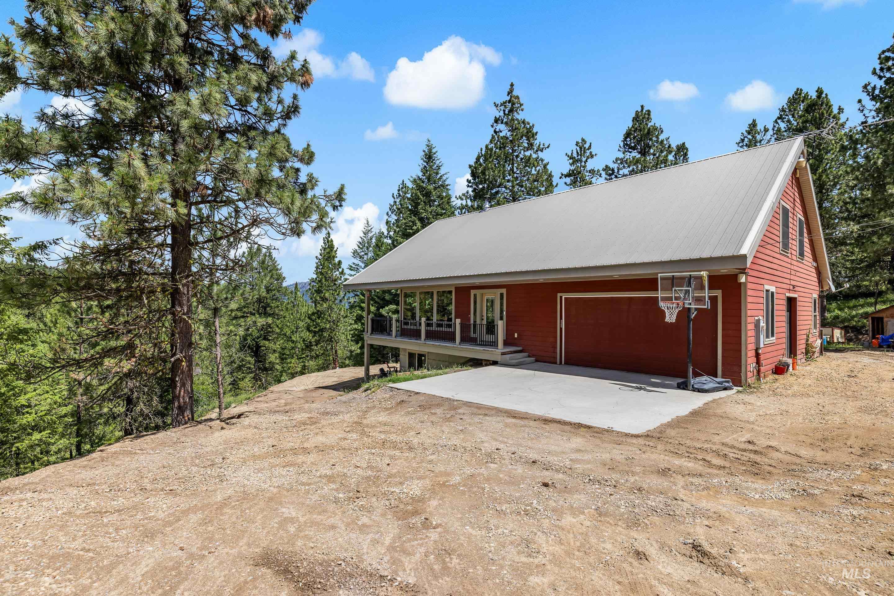 Red siding exterior with a light gray metal roof