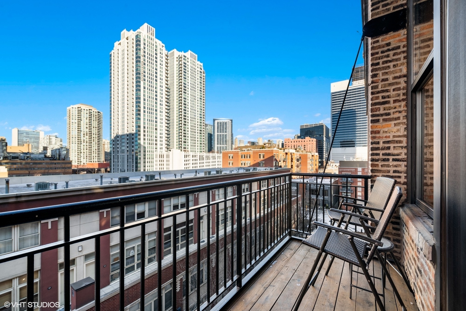 616 West Fulton Street, Unit 501 Chicago, IL 60661 - Photo 2 of 4 a view of balcony with a couple of cars parked in city