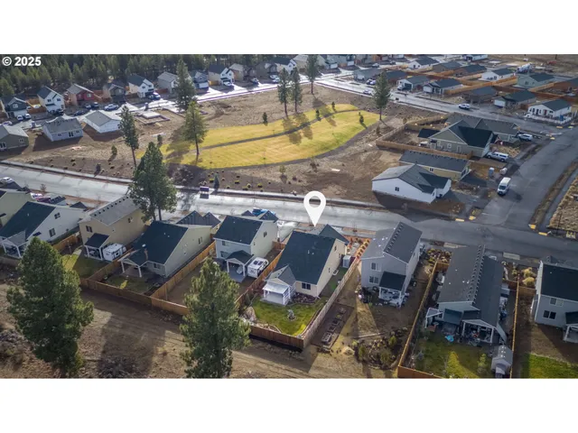 a aerial view of a house with a swimming pool outdoor seating and yard