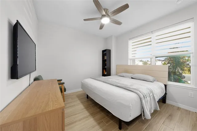 a bedroom with a bed and a flat screen tv