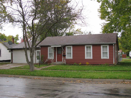 116 South 9th Street Rochelle, IL 61068 - Photo 1 of 9 a front view of a house with a garden and trees