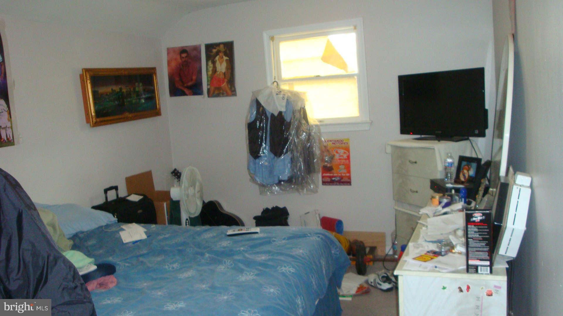 2505 Weisman Road Silver Spring, MD 20902 - Photo 14 of 19 a bedroom with a bed and flat screen tv