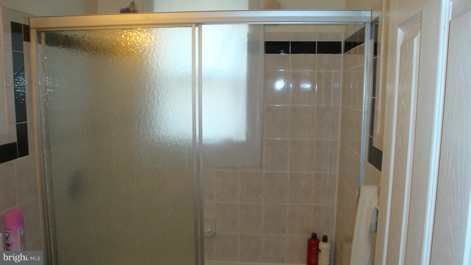 2505 Weisman Road Silver Spring, MD 20902 - Photo 17 of 19 a bathroom with a glass shower door