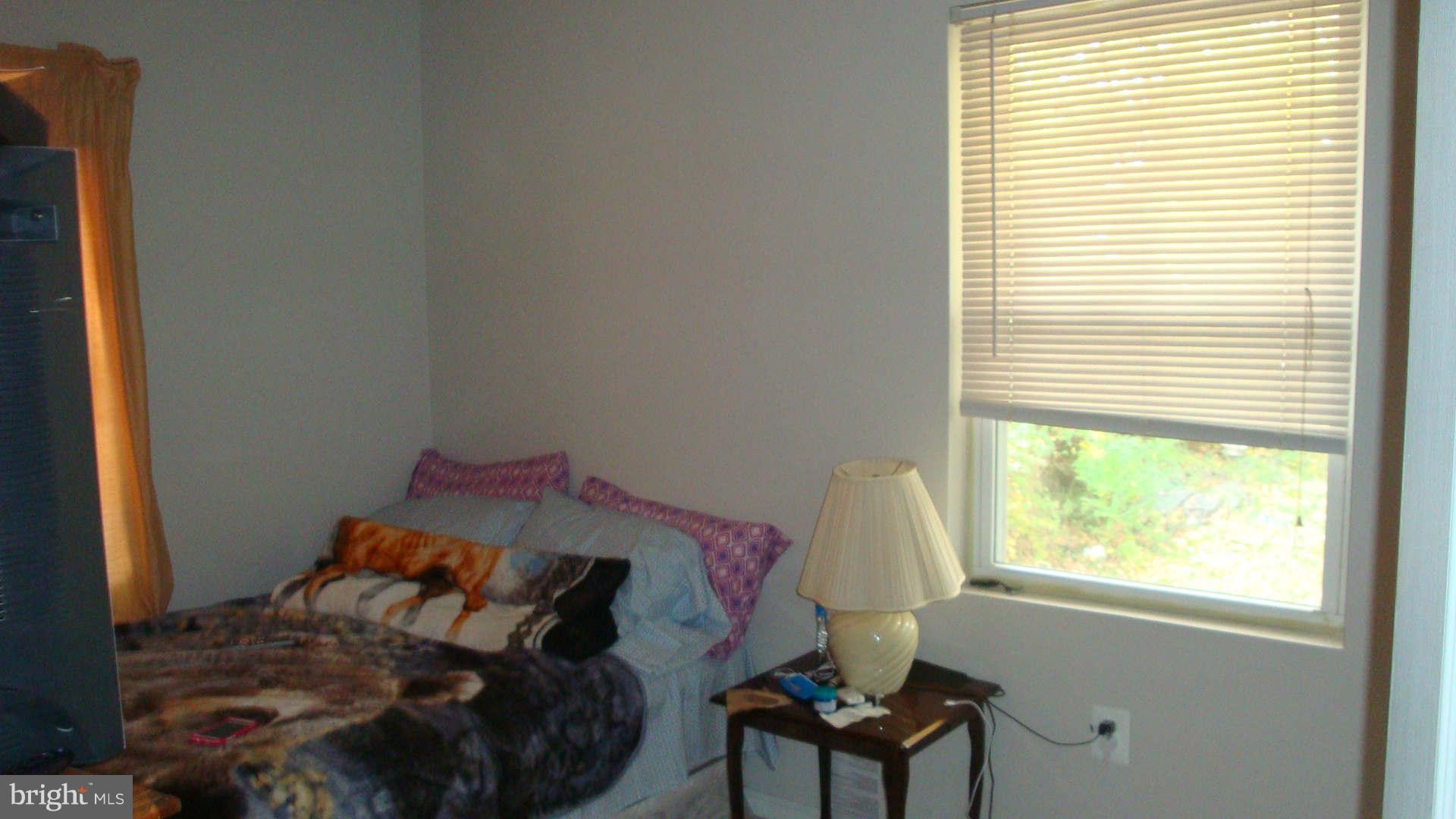 2505 Weisman Road Silver Spring, MD 20902 - Photo 19 of 19 a bed sitting in a bedroom next to a window