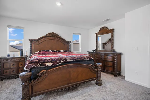 a bedroom with a bed and window