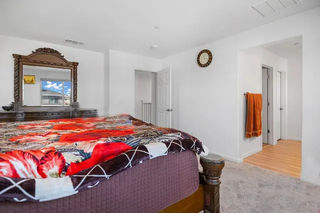 a bedroom with a bed and a dresser