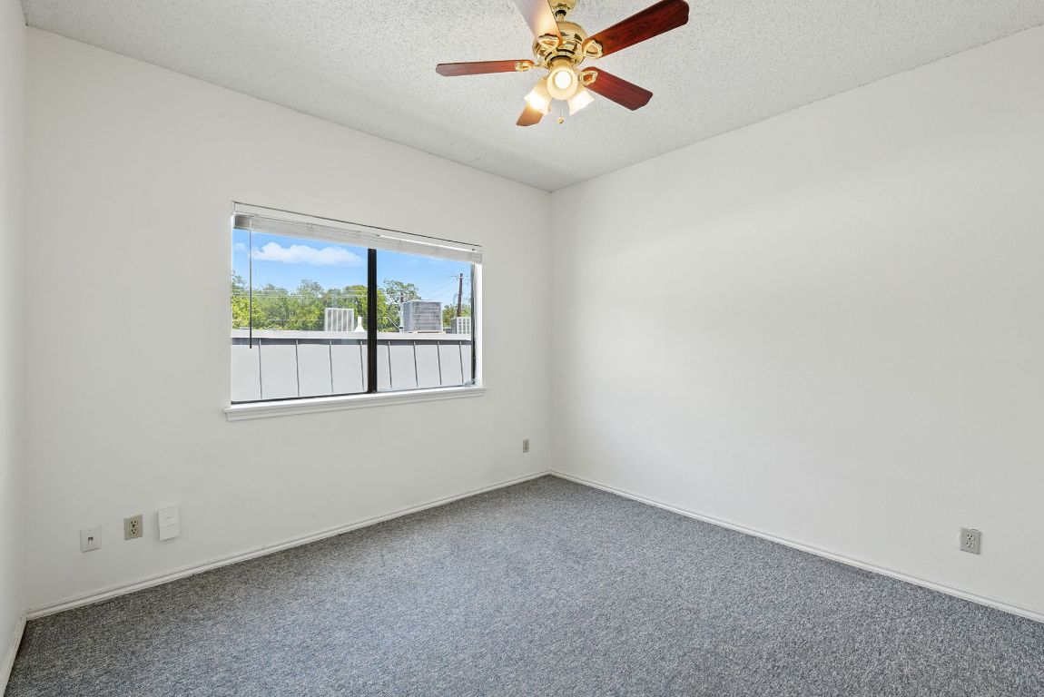 4409 Speedway, Unit 201 Austin, TX 78751 - Photo 10 of 16 Carpeted spare room featuring a textured ceiling and ceiling fan
