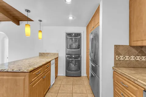 a kitchen with stainless steel appliances white cabinets and a granite counter tops