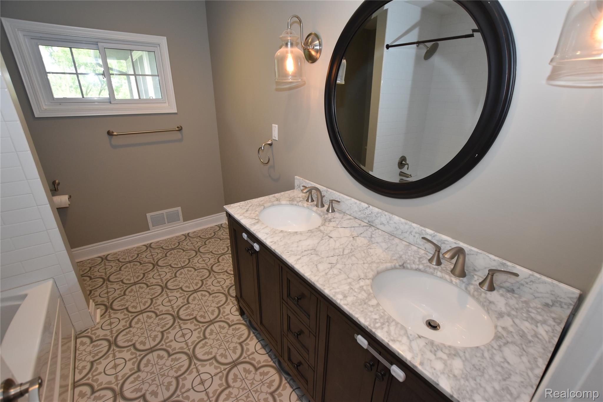 9497 Ellis Road Clarkston, MI 48348 - Photo 13 of 25 Double vanity with under-mount sinks and a stone countertop