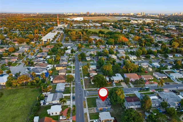 an aerial view of residential houses with outdoor space and swimming pool