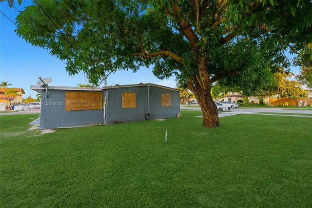 a view of backyard of house with green space