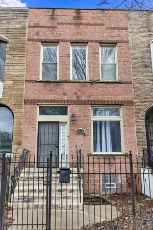 a view of a brick house with large windows
