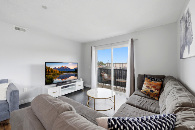 116 East Resaca Drive, Unit F6 Sandy, UT 84070 - Photo 8 of 32 Living area featuring dark flooring and light-toned walls