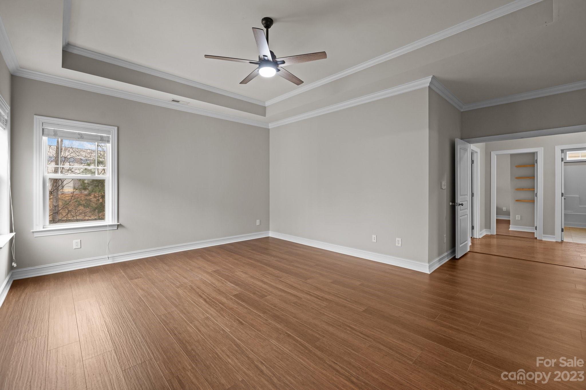 10304 Glenmeade Road Cornelius, NC 28031 - Photo 11 of 47 a view of an empty room with wooden floor and a window