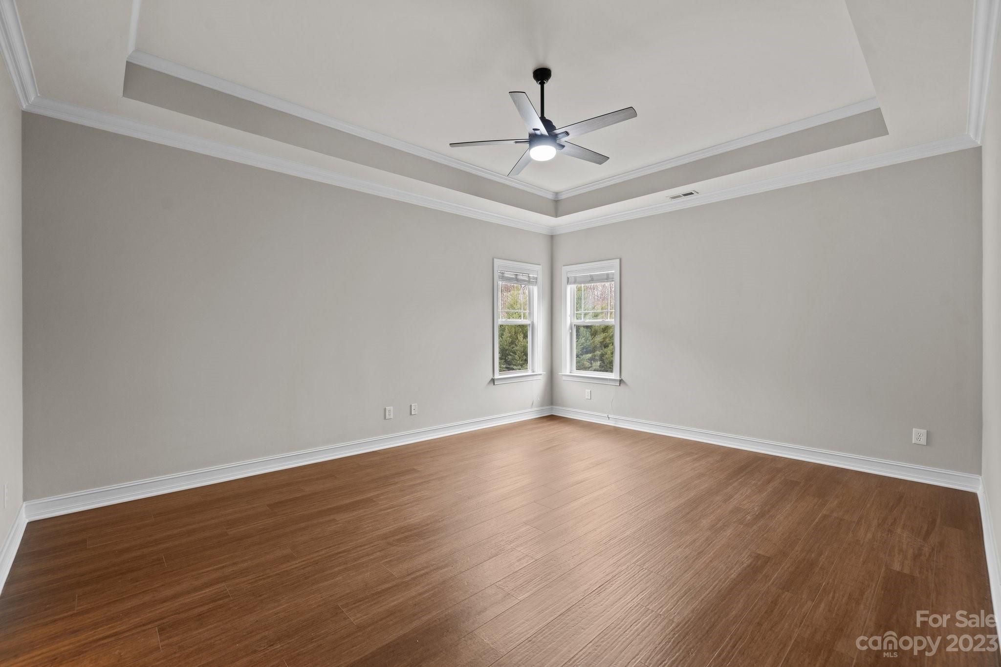 10304 Glenmeade Road Cornelius, NC 28031 - Photo 13 of 47 a view of an empty room with wooden floor and a window
