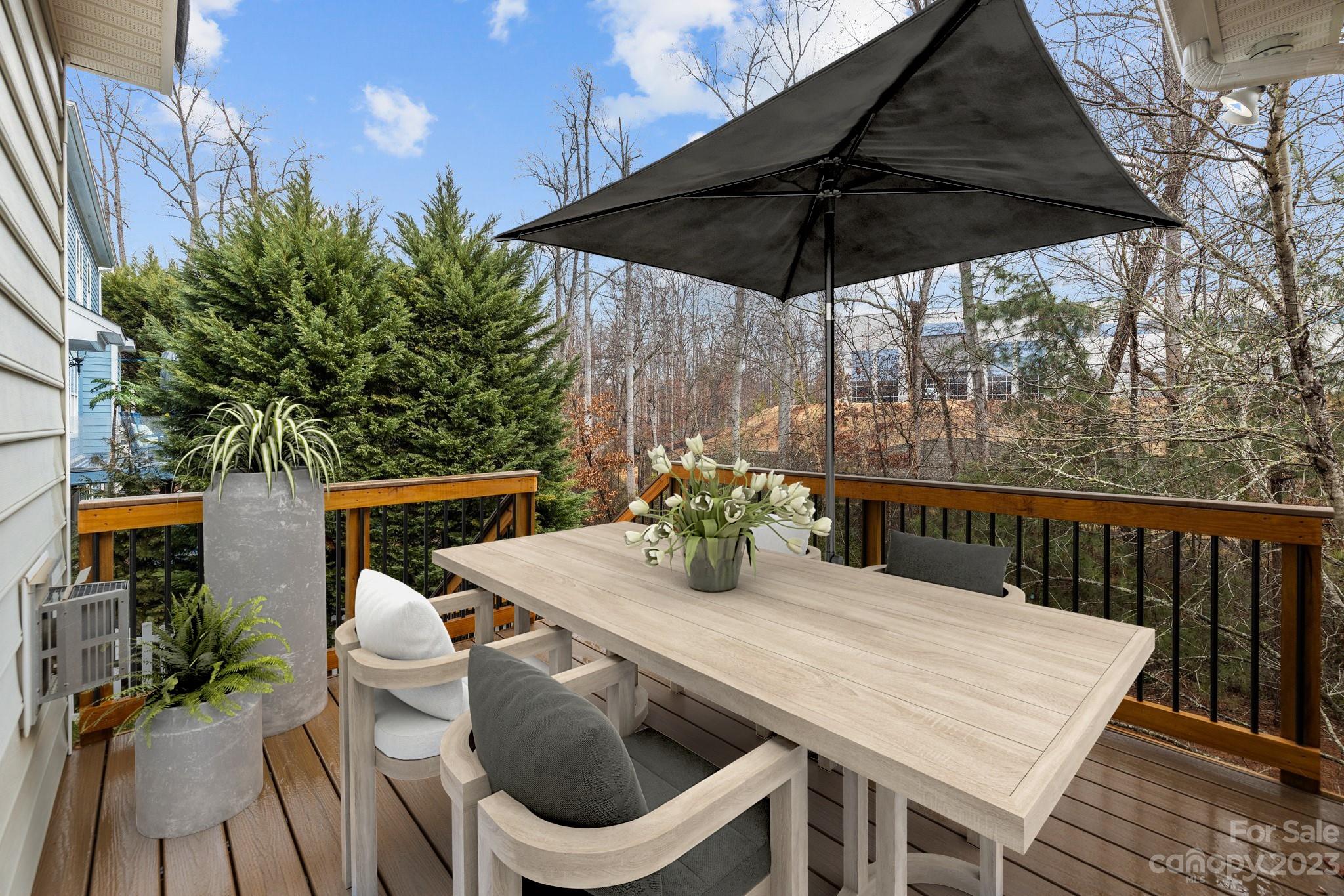 10304 Glenmeade Road Cornelius, NC 28031 - Photo 20 of 47 a table and chairs with the umbrella in the balcony