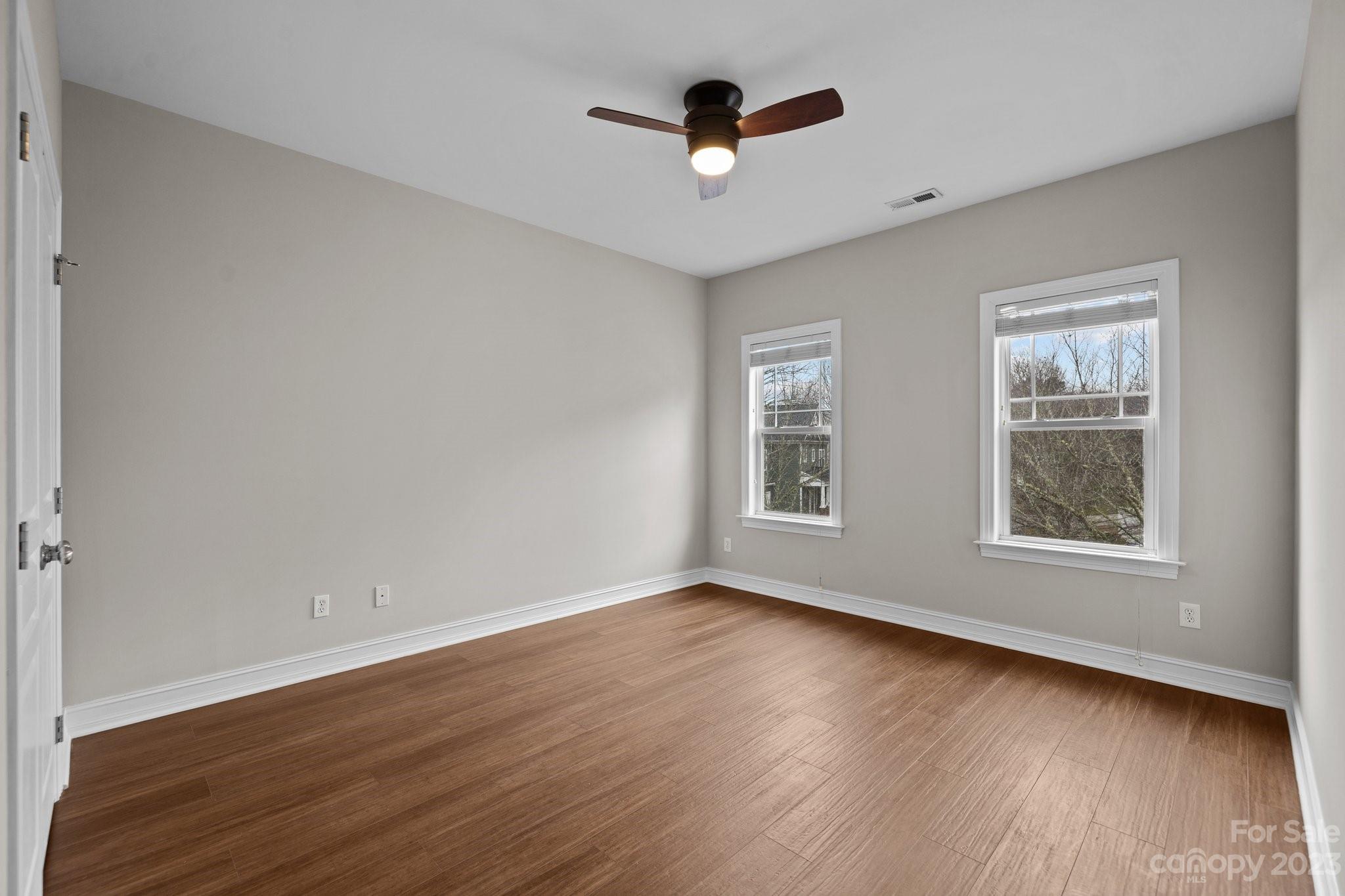 10304 Glenmeade Road Cornelius, NC 28031 - Photo 33 of 47 a view of an empty room with wooden floor and a window