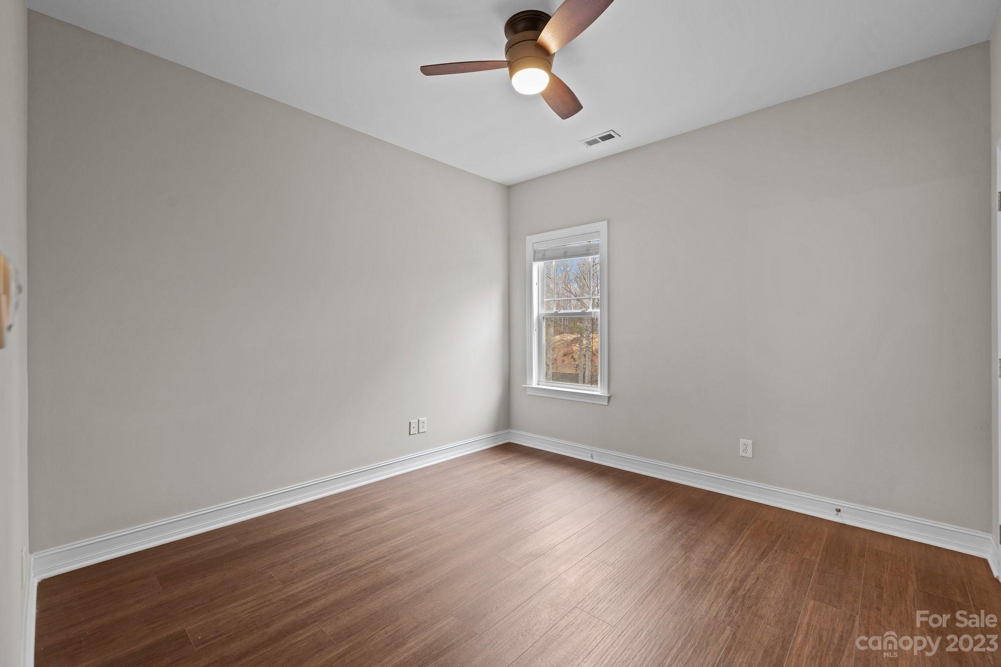 10304 Glenmeade Road Cornelius, NC 28031 - Photo 36 of 47 wooden floor in an empty room with a window