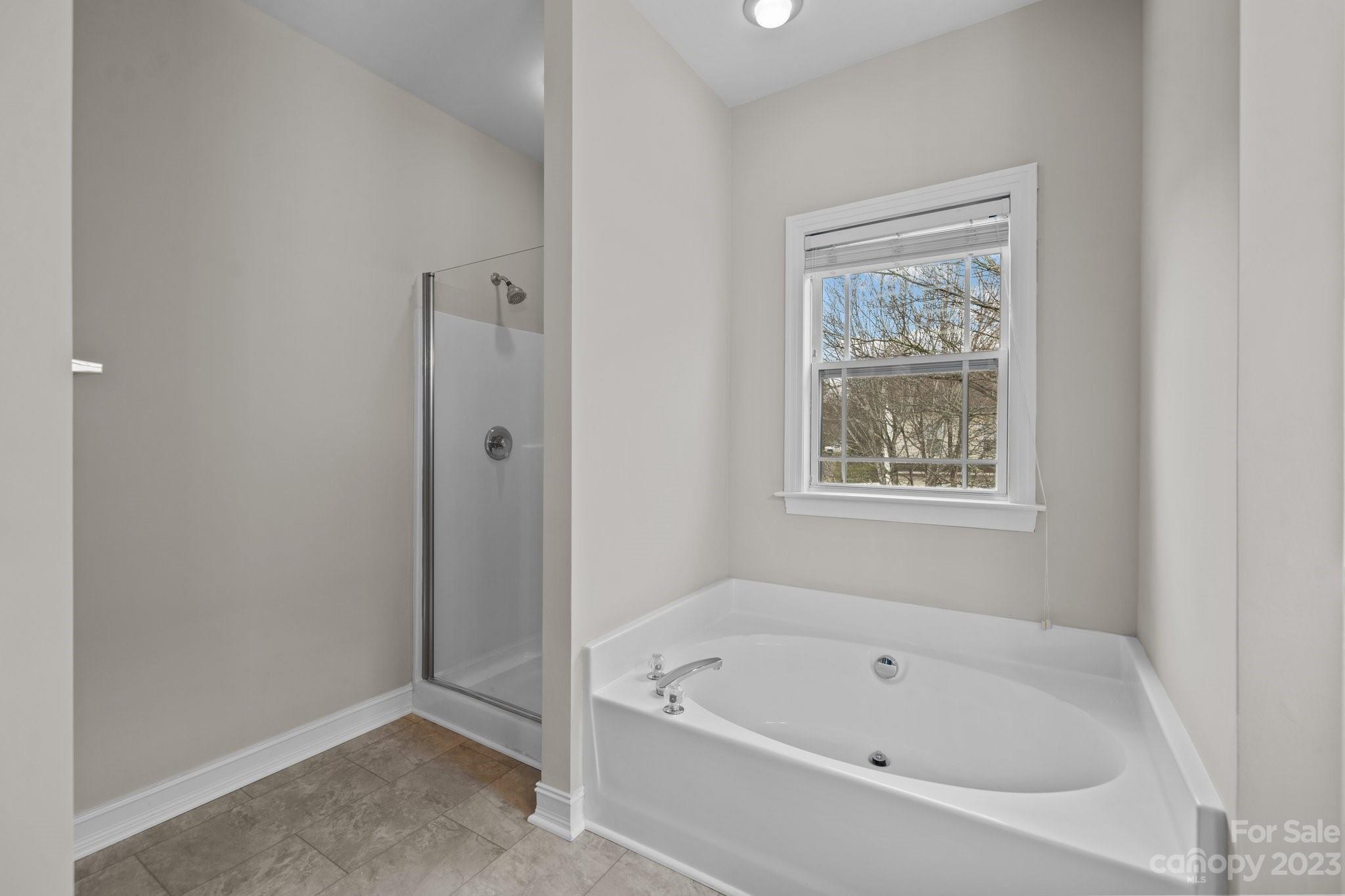 10304 Glenmeade Road Cornelius, NC 28031 - Photo 39 of 47 a white bath tub sitting next to a shower