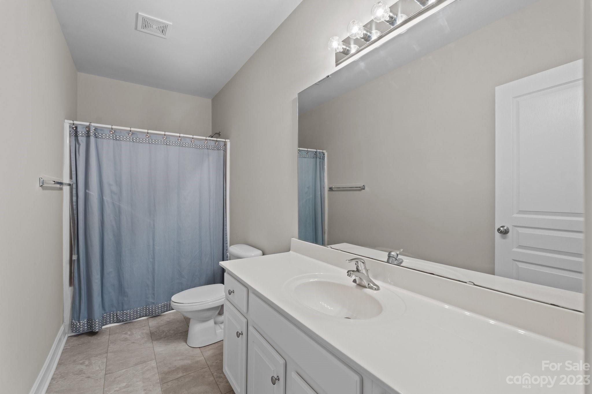 10304 Glenmeade Road Cornelius, NC 28031 - Photo 41 of 47 a bathroom with a sink and mirror with toilet