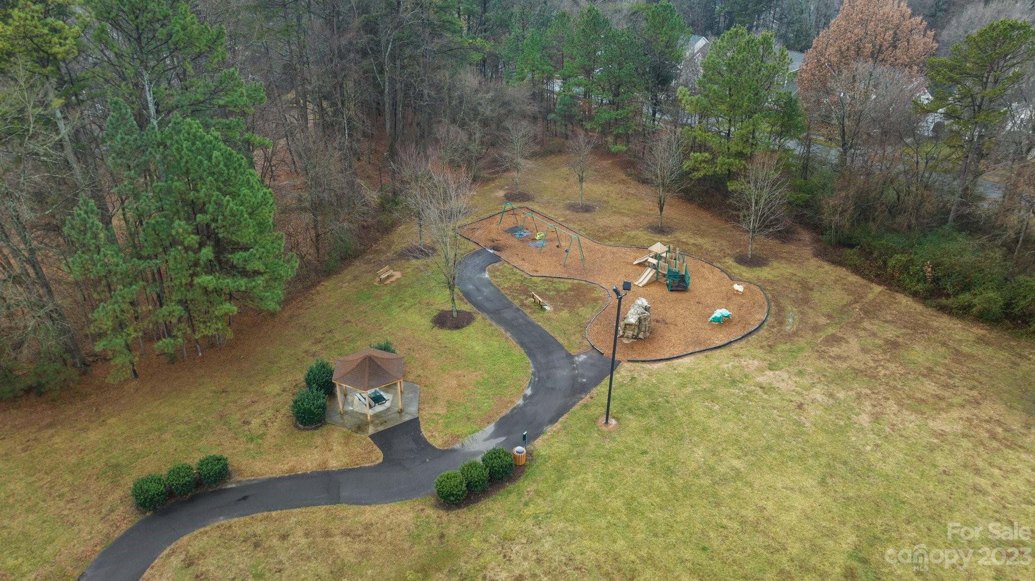 10304 Glenmeade Road Cornelius, NC 28031 - Photo 46 of 47 an aerial view of a house with a yard and trees