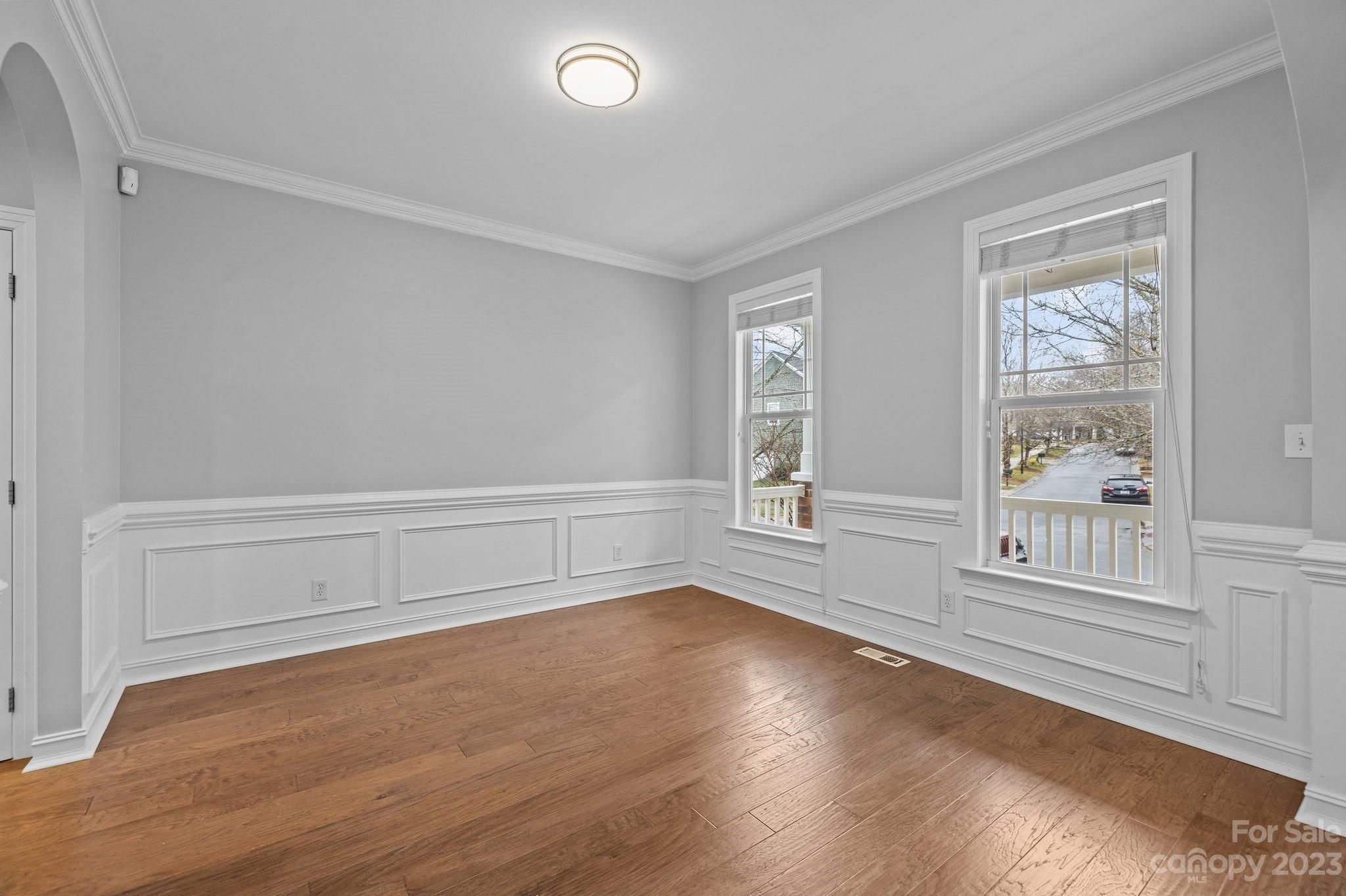 10304 Glenmeade Road Cornelius, NC 28031 - Photo 9 of 47 an empty room with wooden floor and windows