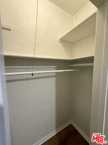 a view of an empty room and wooden floor