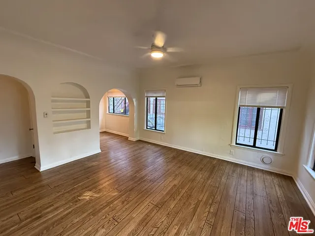 a view of a room with wooden floor and window