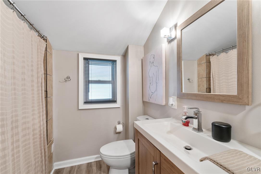 1226 Railroad Street Bethlehem, PA 18015 - Photo 17 of 20 a bathroom with a sink toilet and mirror
