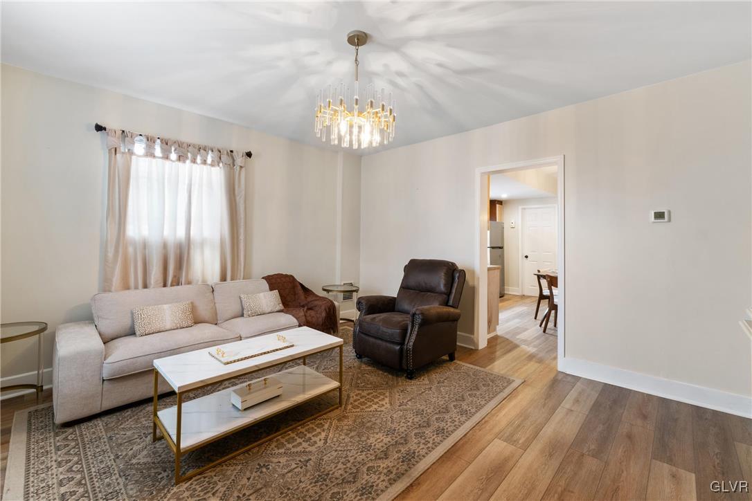 1226 Railroad Street Bethlehem, PA 18015 - Photo 4 of 20 a living room with furniture a chandelier and a window