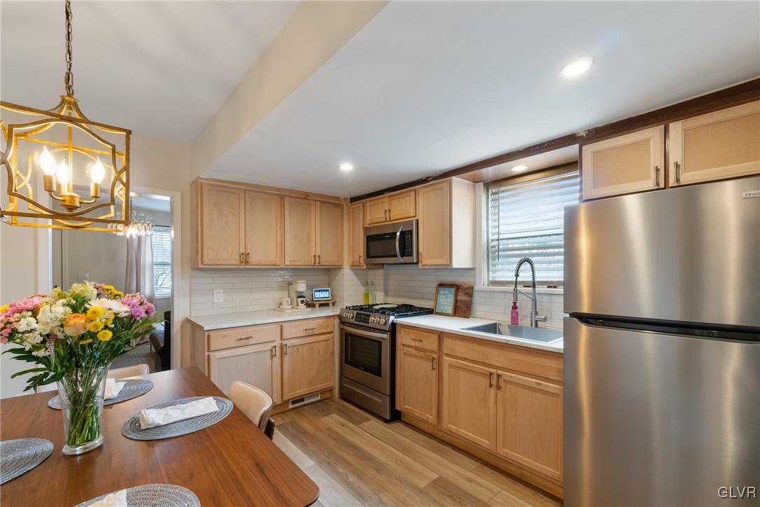 1226 Railroad Street Bethlehem, PA 18015 - Photo 6 of 20 a kitchen with stainless steel appliances granite countertop a refrigerator sink and white cabinets