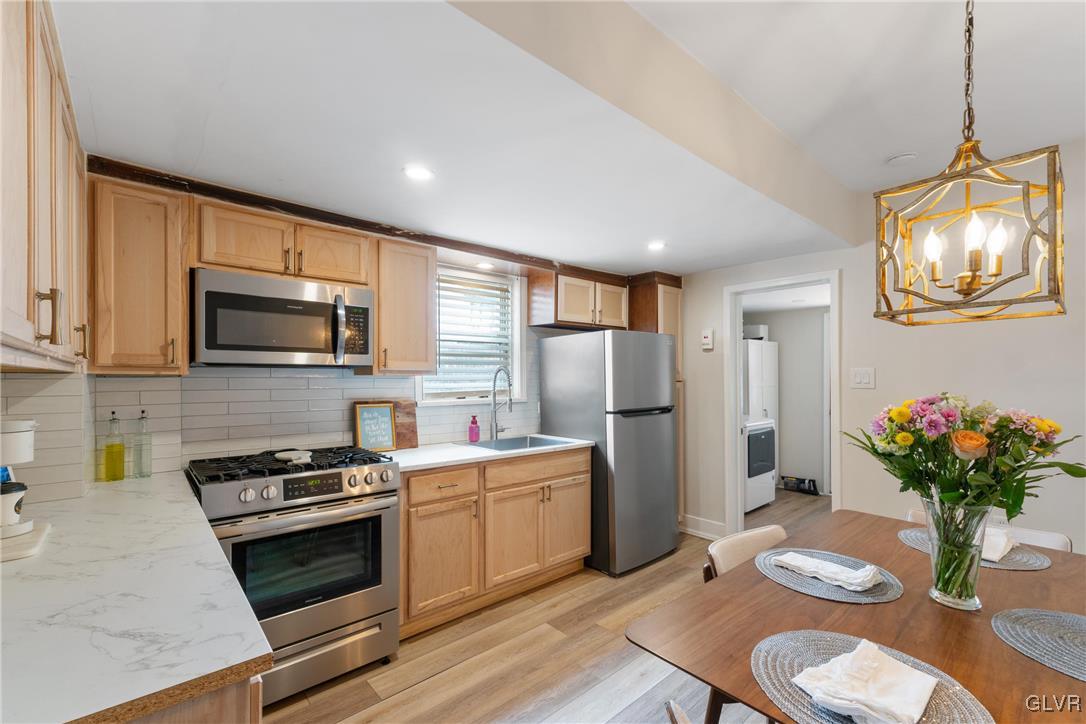 1226 Railroad Street Bethlehem, PA 18015 - Photo 7 of 20 a kitchen with stainless steel appliances a stove a sink a microwave a refrigerator and cabinets