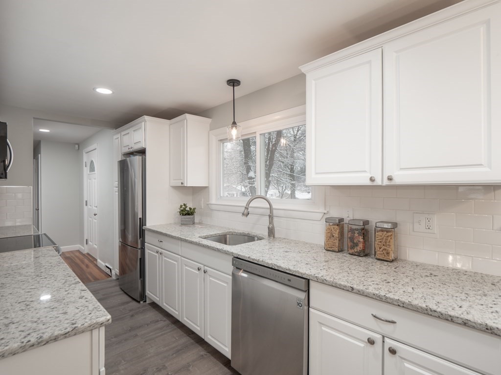 39 Marilyn Road Andover, MA 01810 - Photo 11 of 28 a kitchen with stainless steel appliances granite countertop a sink a stove and a refrigerator
