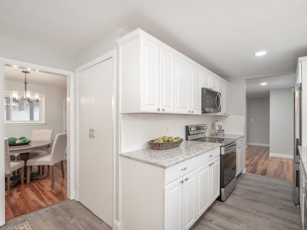 39 Marilyn Road Andover, MA 01810 - Photo 15 of 28 a kitchen with a sink stove and cabinets