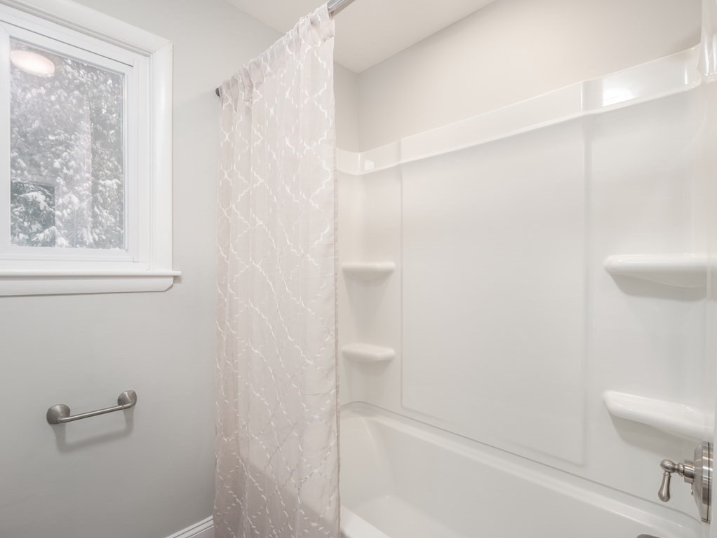 39 Marilyn Road Andover, MA 01810 - Photo 21 of 28 a bathroom with a bathtub and shower