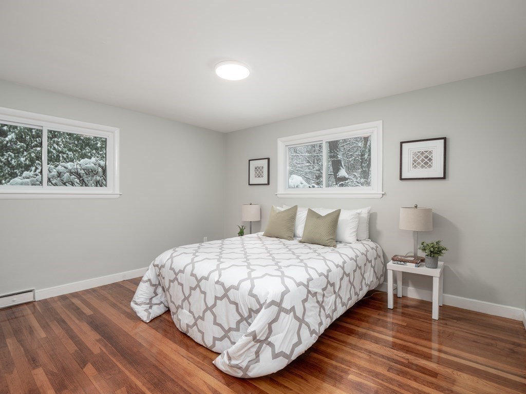 39 Marilyn Road Andover, MA 01810 - Photo 22 of 28 a bedroom with a bed and wooden floor